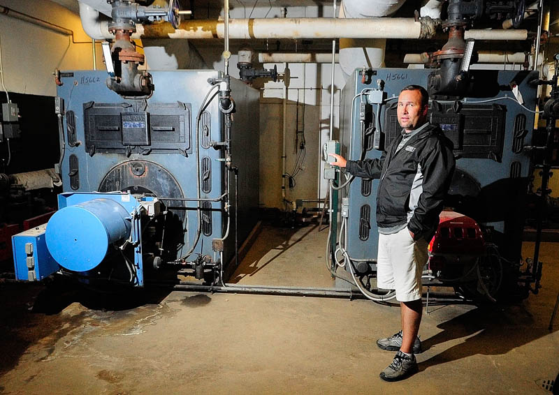 Director of Operations Jon Stonier talks about plans to convert one of the two burners in the Gardiner Area High School boiler room from oil to natural gas, during an interview today in Gardiner.