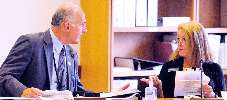 Rep. Dennis Keschl, R-Belgrade, left, and Rep. Kathleen Chase, R-Wells, confer over a draft version of L.D. 1515 before a work session of the Appropriations and Financial Affairs committee on Thursday at the State House in Augusta.