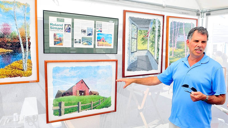 Roland Simard describes how he makes his art from pigmented pulp at the 26th annual Winthrop Sidewalk Art Show today in downtown Winthrop.