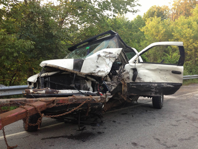 One of two pickup trucks involved in a double-fatal, head-on collision on Riverside Drive in Vassalboro this afternoon is attached to a wrecker.