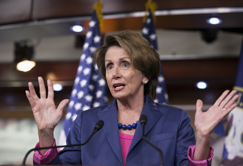 House Minority Leader Nancy Pelosi of California gestures while speaking during a news conference on Capitol Hill in Washington on Friday as Congress continues to struggle over how to fund the government and prevent a possible shutdown.