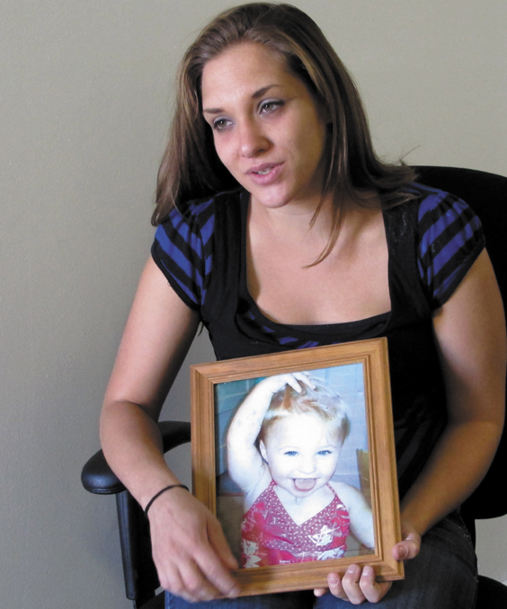 Trista Reynolds, 25, holds a photo of her 20-month-old daughter, Ayla Reynolds, during an interview with the Associated Press in Westbrook, Maine, Tuesday. Reynolds, whose daughter went missing in December of 2011, says she's going to release more information she's been told by investigators in hopes of calling attention to the case and bringing it to a resolution.