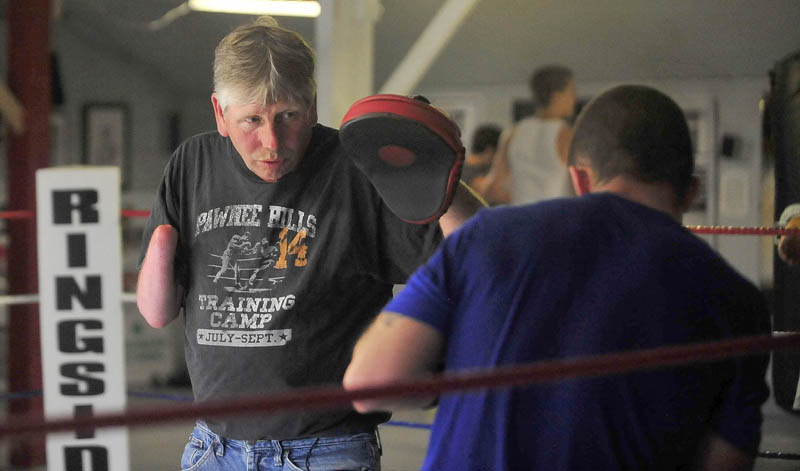 Skeet Wyman works the pads with Brandon Berry, who travels three days a week about 225 miles round trip to train at Wyman's Boxing Club in Stockton Springs.