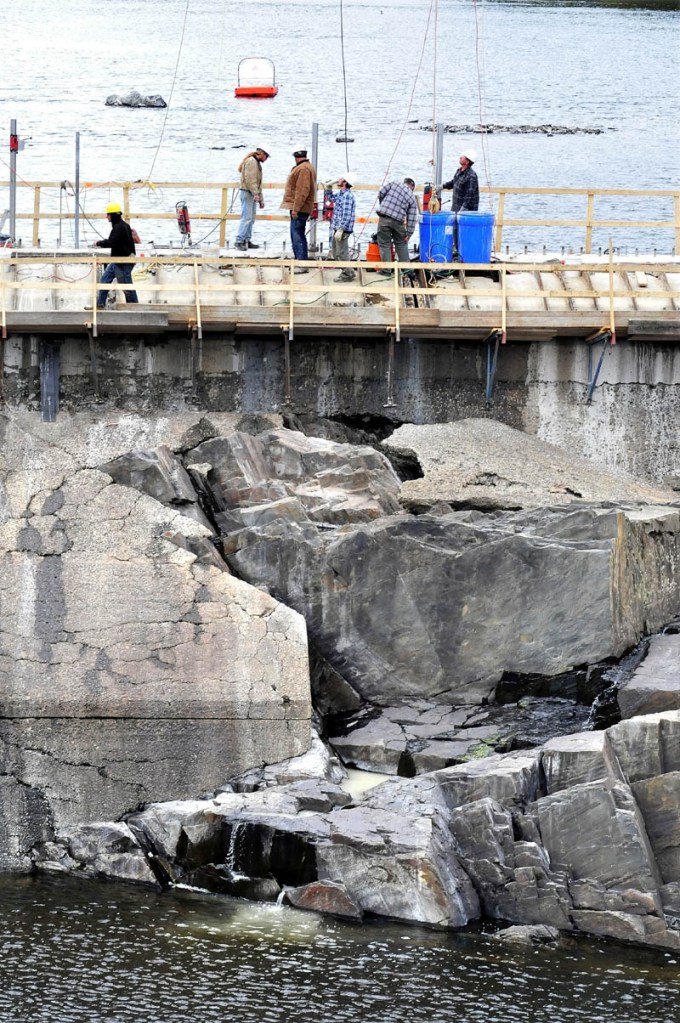 Men work on the top of the Brookfield Renewable Energy dam on the Kennebec River in Skowhegan this week.