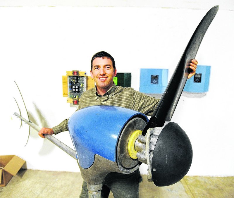 Ben Polito, president of Pika Energy in Westbrook, holds one of three blades on a personal-size wind turbine. Polito said he appreciates the mentoring he gets from investors.