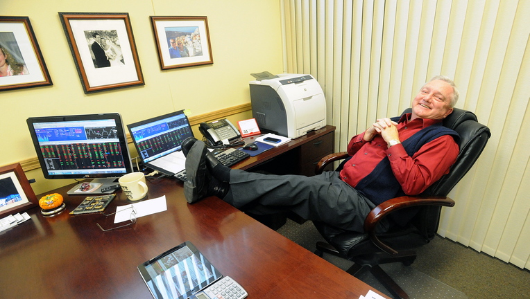 Up Late: David Smith, branch manager for Raymond James Financial Services in Waterville, relaxes Thursday staying up late to watch the Red Sox win the World Series.