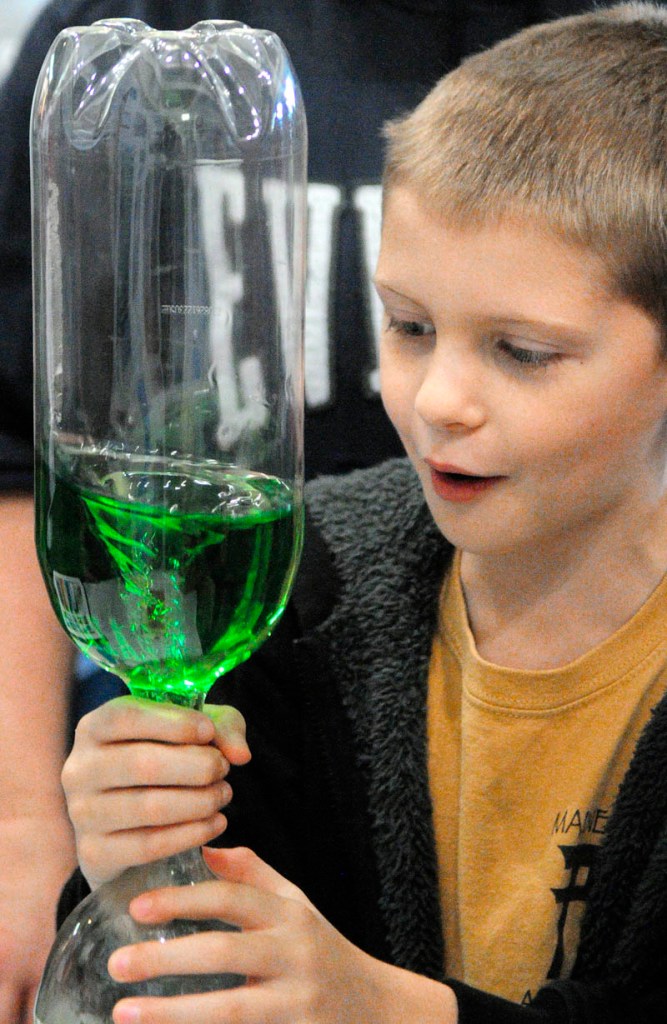 Braedyn Stockmar, of Augusta, watches a vortex forms inside a tornado tube during Earth Science Day on Wednesday at Maine State Museum in Augusta.