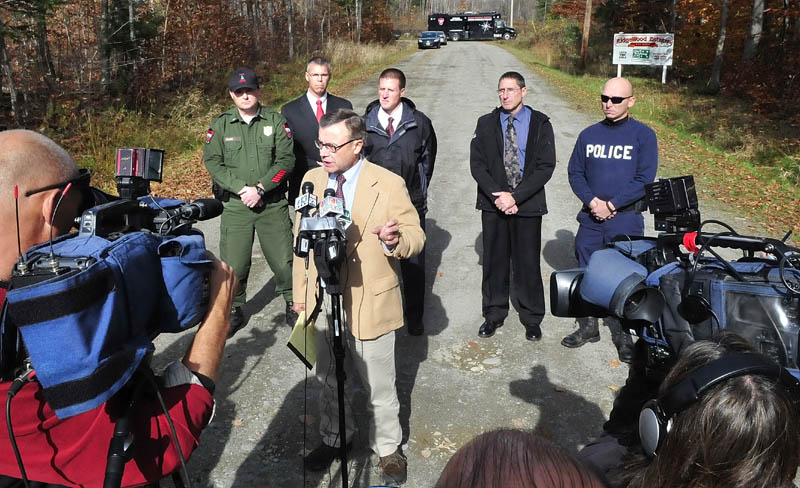Steve McCausland, spokesman for the Maine Department of Public Safety, is surrounded by law enforcement officers and media during a press conference on Nike Lane in Oakland on Wednesday, following a search for missing toddler Ayla Reynolds.