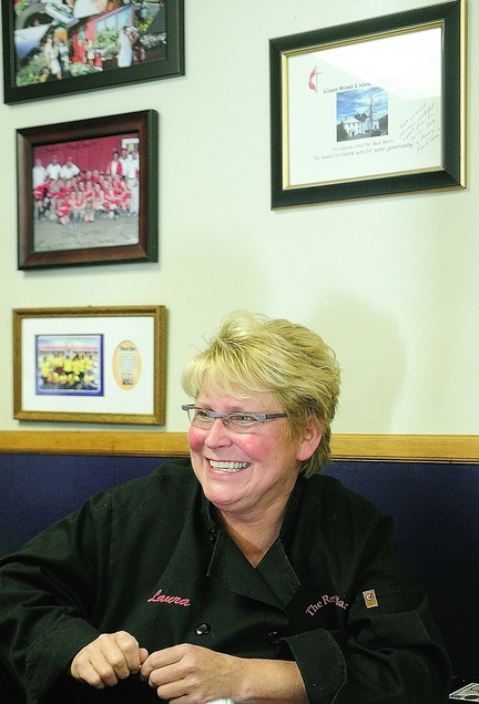 Legacy of Charity: Sitting beside several framed thank-you notes from organizations that benefited from Red Barn fundraisers, owner Laura Benedict talks to a reporter Saturday at The Red Barn in Augusta.