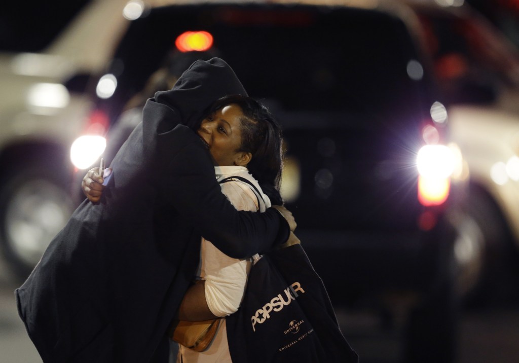 A woman is reunited with a man in the parking lot of Garden State Plaza Mall on Tuesday morning.