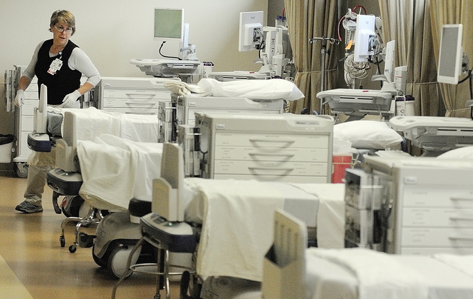 Nurse Jane Landry puts sheets on stretchers in the post anesthesia care unit on friday at the Alfond Center for Health in Augusta.