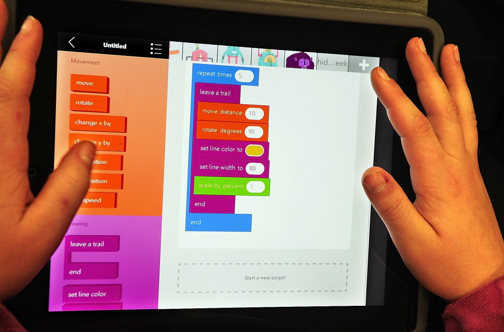 HOUR OF CODE: Jacek Twarog, a sixth-grader from Fayette, writes a program in the Hopscotch app on an iPad on Friday at Maranacook Middle School in Readfield.
