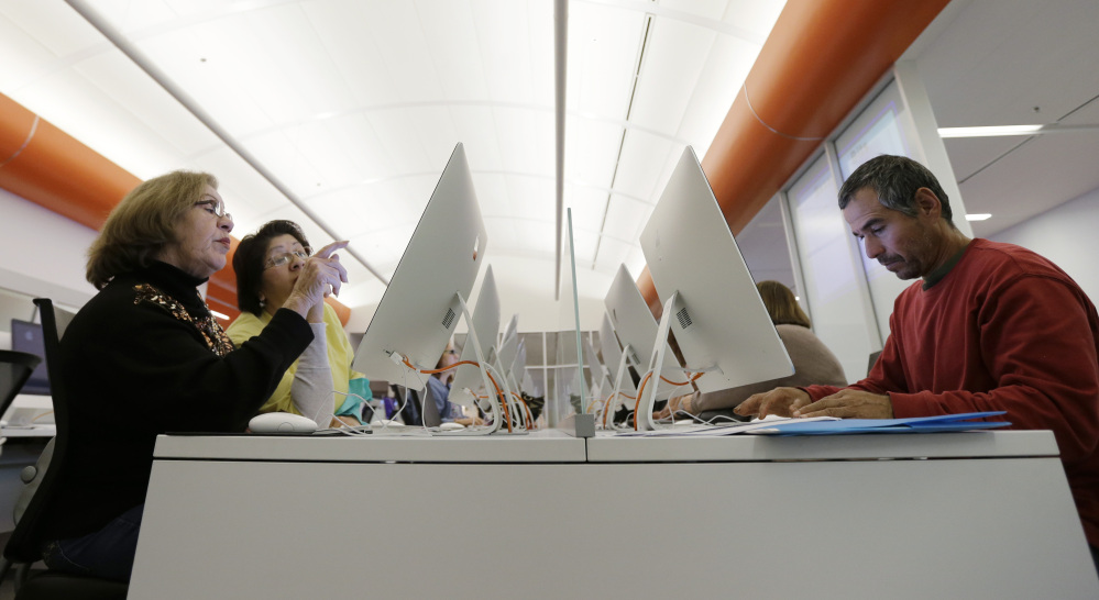 Patrons use computers at a San Antonio public library to access the Affordable Health Care Act website. The deadline to sign up for January coverage was Christmas Eve.