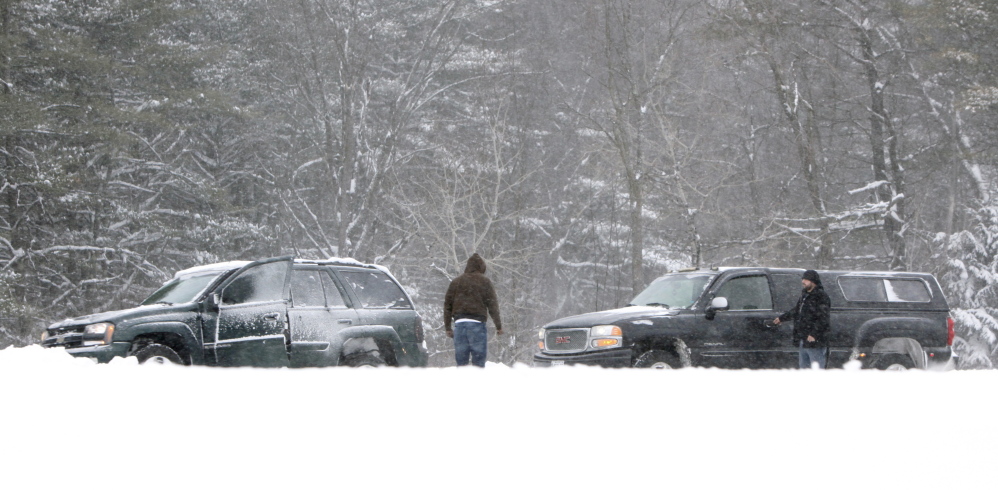 A driver of a truck stops to help someone whose car got stuck in a snowbank in the southbound lane of the Maine Turnpike in Arundel on Friday. Experts debunk some of the myths about operating motor vehicles and staying warm in cold and snowy weather.