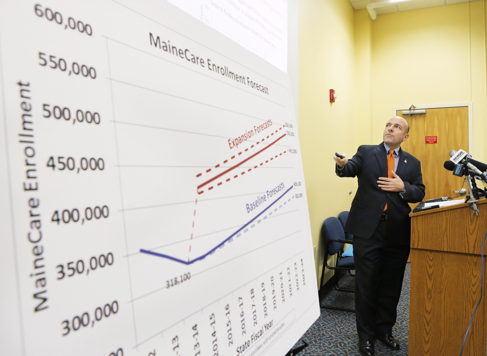 Gary Alexander of the Alexander Group presents his analysis of a report his group developed regarding the cost of expanding MaineCare at the Department of Health and Human Services in Augusta on Friday, January 10, 2014.