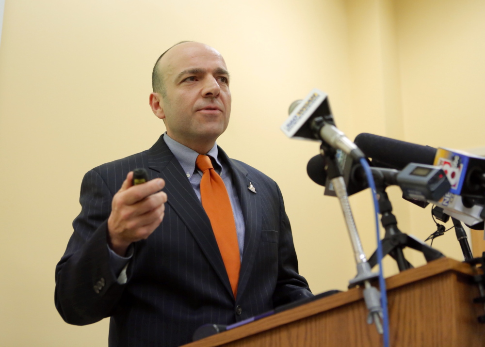 Gary Alexander of the Alexander Group presents his analysis of a report his group developed regarding the cost of expanding MaineCare at the Department of Health and Human Services in Augusta on Friday, January 10, 2014.