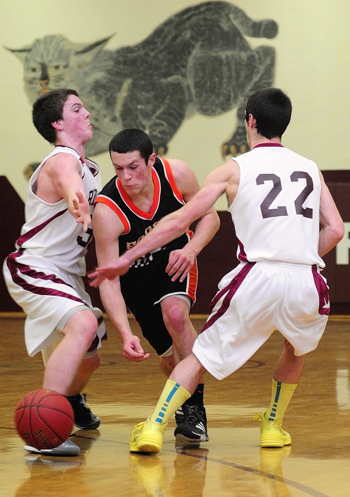 Staff photo by Joe Phelan Forest Hills' Matt Turner, middle, is double teamed by Richmond's Matt Holt, left, and Tyler Soucy during game on Friday January 10, 2014 at RIchmond High School.