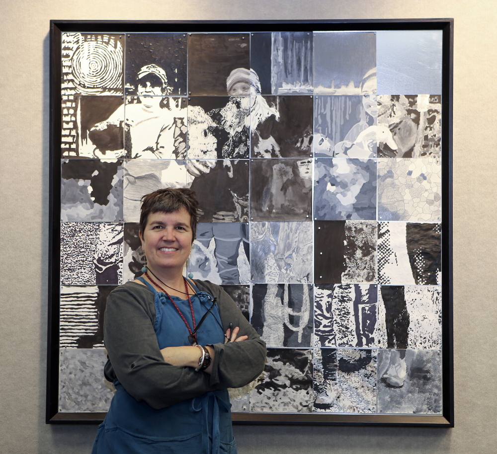 Growers in a grid: University of Maine at Augusta art instructor Susan Bickford poses in front of a portrait of the Perry family from Winterberry Farm in Belgrade. It’s one of 10 portraits of local organic farmers assembled from squares completed by students at 10 central Maine schools. Bickford organized the project, which culminates in an exhibit opening Thursday at UMA’s Danforth Gallery.