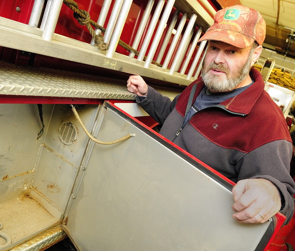 Staff photo by Joe Phelan Whitefield Fire Chief Scott Higgins talks about the rust on department’s 1980 FMC tanker during an interview on Friday January 17, 2014 in Coopers Mills Fire Station. There are plans to replace both it and another truck with one new truck.