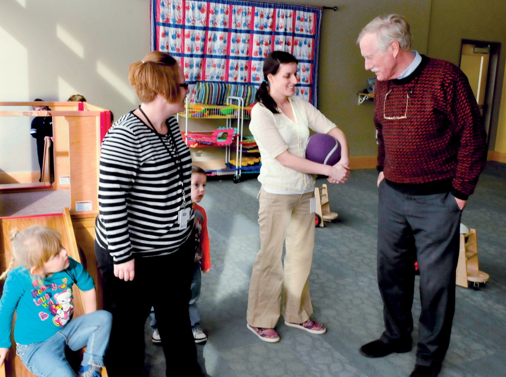 BACK TO SCHOOL: U.S. Sen. Angus King speaks with Educare Central Maine employees Jessica Field, left, and Amy Pinkham in one of the classrooms at the Waterville facility on Wednesday, Jan. 22, 2014.