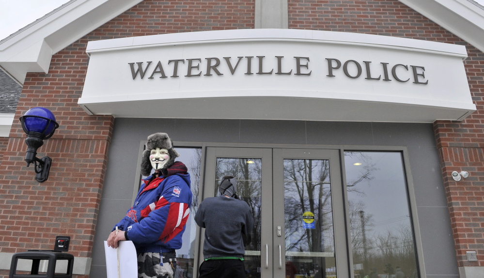 protest: Mark Leighton, of Gardiner, wears a mask Saturday as he takes part in the Push for Prosecution protest in the Ayla Reynolds case at the police station in Waterville.