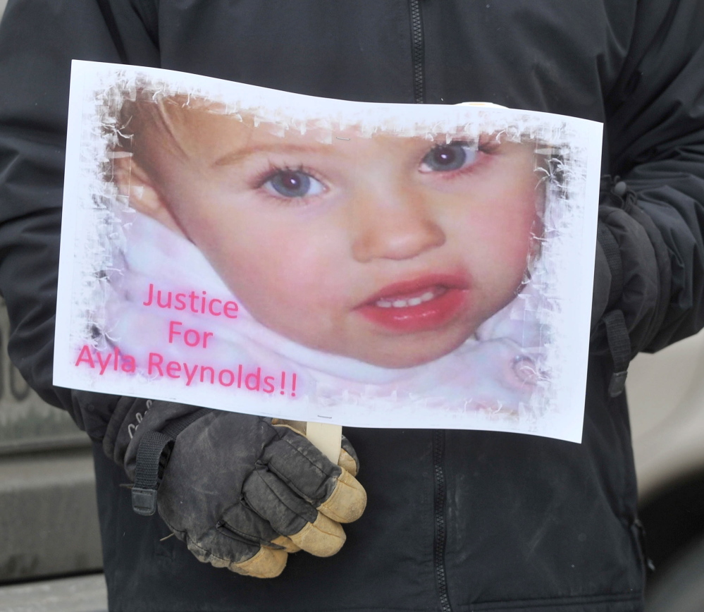 poster child: A poster with the image of missing toddler Ayla Reynolds was one of many signs on hand at a demonstration Saturday at the Waterville police station.