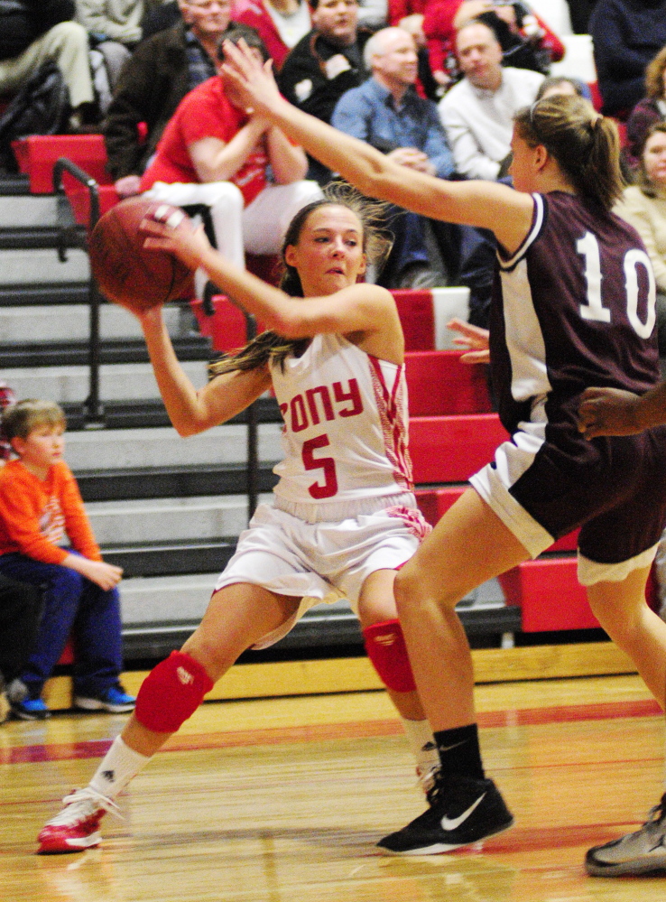 Staff photo by Joe Phelan Cony's Emily Quirion, left, tries to look around Edward Little's Sarah Hammond for a teammate to pass the ball to during a game on Tuesday February 4, 2014 at Cony High School in Augusta.