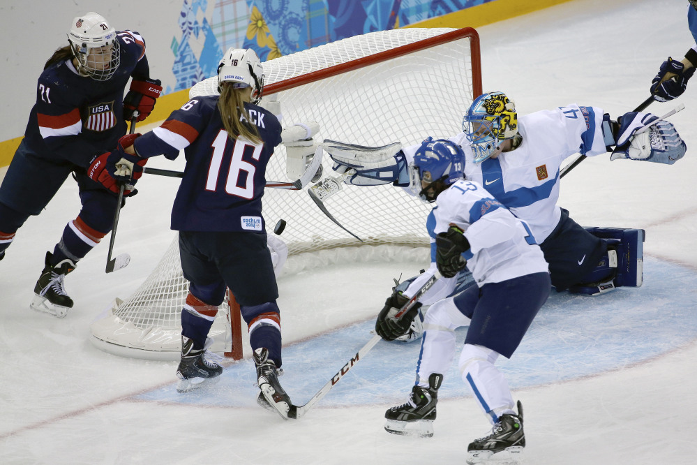 Kelli Stack of the Untied States, 16, scores a goal on an assist from Hilary Knight, 21, of the Untied States as goalkeeper Noora Raty of Finland tries to block the shot during the second period.