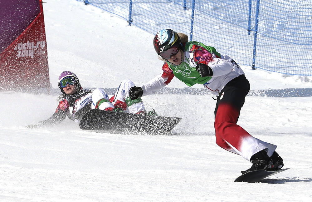 Canada’s Dominique Maltais, right, reacts after winning the semifinal of the women’s snowboard cross competition at the Rosa Khutor Extreme Park.