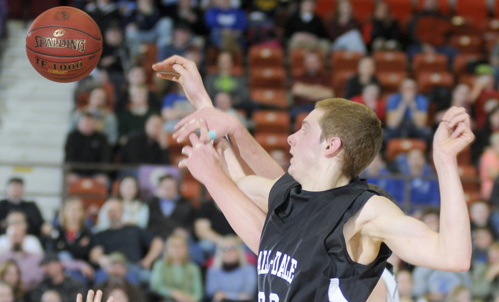 Staff photo by Andy Molloy Hall-Dale High School's Wesley Lapointe blocks a shot by Waynflete School's Serge Nyirikamba during a tournament match up Thursday in Augusta.