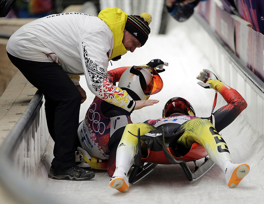 The doubles team of Tobias Wendl and Tobias Arlt from Germany celebrate in the finish area after their final run to win the gold medal during the men's doubles luge at the 2014 Winter Olympics, Wednesday, Feb. 12, 2014, in Krasnaya Polyana, Russia.