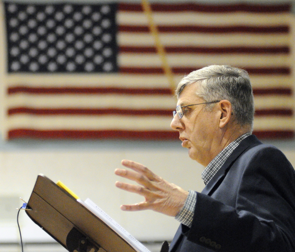 Moderator: Selectman Donald Grinnell answers a resident’s question during debate about cemetery maintenance during Washington’s Town Meeting on Saturday in Prescott Memorial School in Washington.