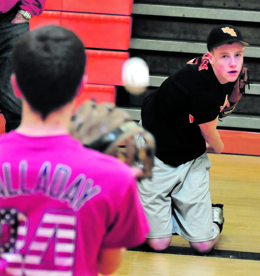 Staff photo by David Leaming Winslow High School baseball pitcher Jake tTrask hrows during on the first day of practice for pitchers and catchers on Monday, March 24, 2014.