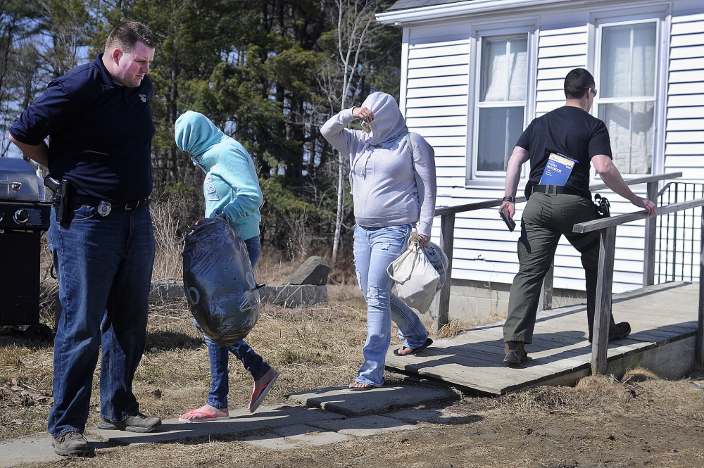 Raid: Women leave the residence Frederick Horne Sr. shares with his son, Frederick Horne Jr., in Sidney on Thursday after a raid by police. The Hornes were summoned on a charge of sex trafficking, with authorities saying at least a half-dozen women were at the home Thursday.