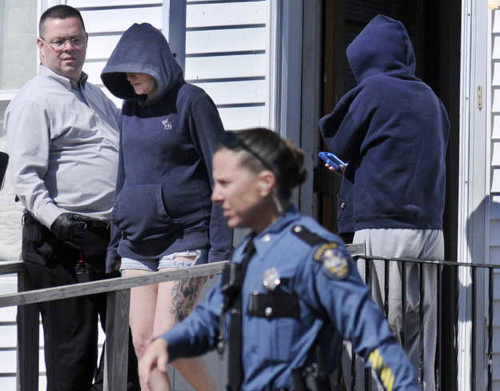 Staff photo by Andy Molloy State Troopers speak with women at the Sidney residence of Frederick Horne Sr. on Thursday following a raid by several law enforcement agencies. Horne and his son, Frederick Horne Jr., were charged with sex trafficking.