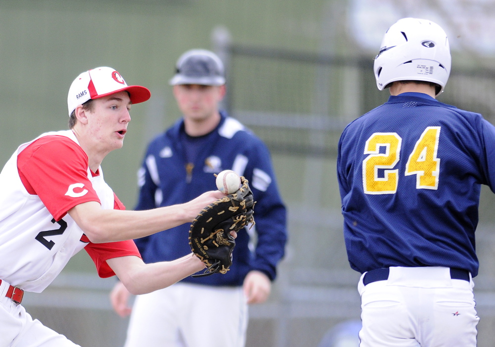 TOUGH HOLD: Cony High School’s Mitchell Bonenfant can’t hold onto a throw Wednesday while attempting to tag Mt. Blue’s Amos Herrin at first base in Augusta. The Cougars beat the Rams 5-2.