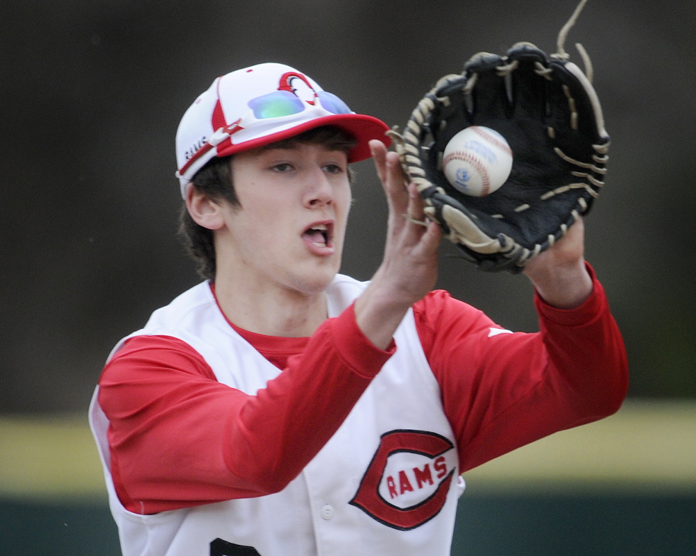 Staff photo by Andy Molloy Cony High School's Thomas Foster collects a bobber at short Wednesday during a baseball match up against Mt. Blue in Augusta.