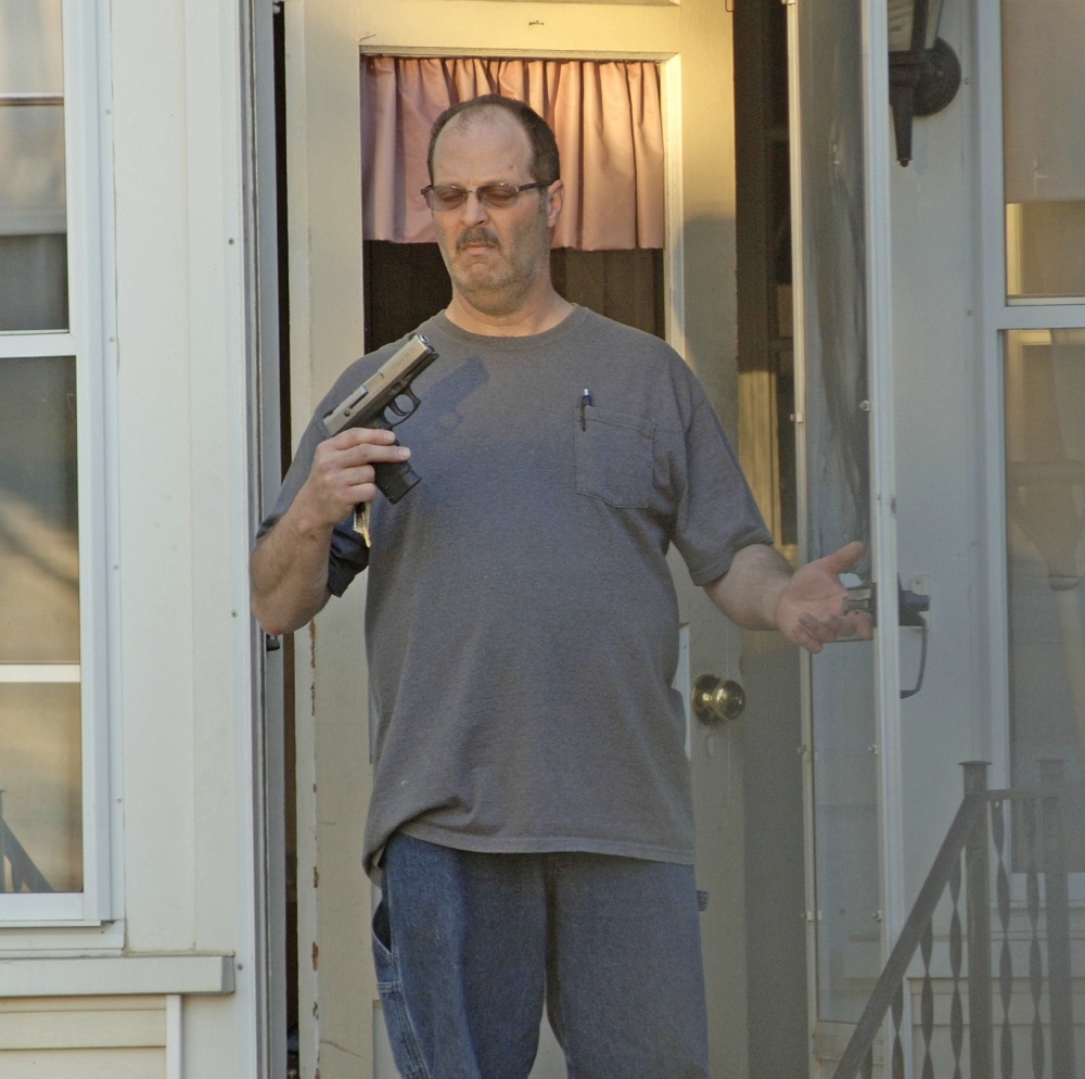 CHARGES: A picture taken by Barry Sturk, Susan Morrisette’s boyfriend, shows her ex-husband, Wilfred Morissette holding a handgun on First Street in Winslow Sunday night. Wilfred Morissette was arrested and charged after he allegedly pointed the loaded gun at Susan Morissette, Sturk and their children.