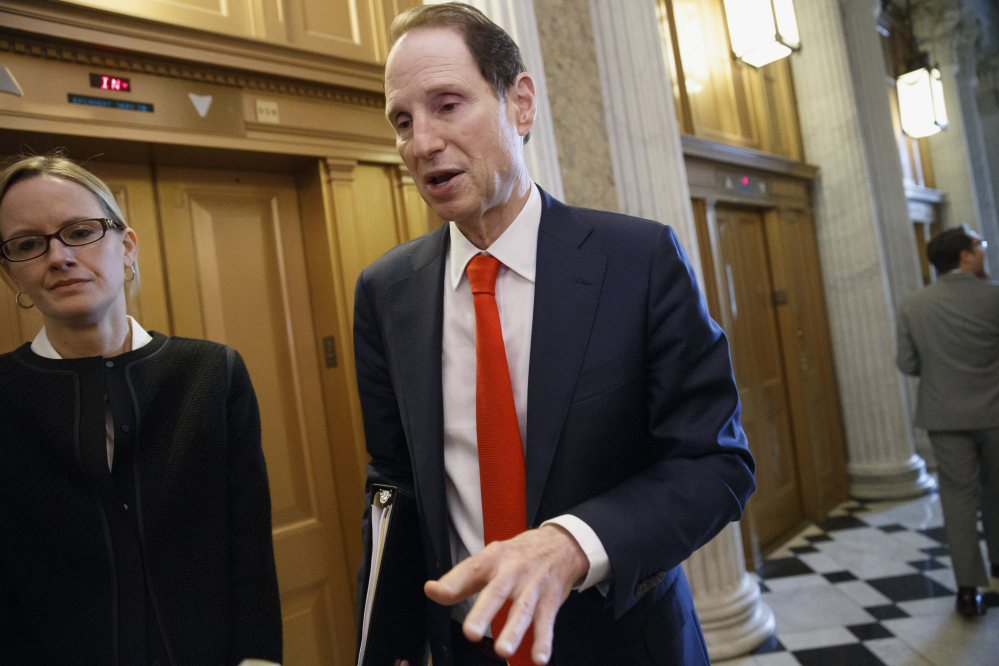 Senate Finance Committee Chairman Sen. Ron Wyden, D-Ore., speaks with reporters about legislation to extend tax breaks as he heads to the chamber for a vote Wednesday on Capitol Hill in Washington. Senate Republicans blocked a bill to renew more than 50 expired tax breaks for businesses and individuals.