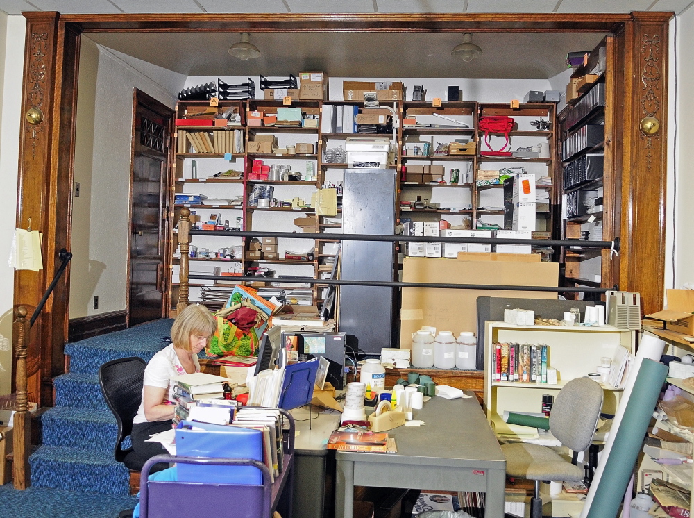 Storage: Framed by what was once used as a stage, but now for storage, Sue Claian works on the top floor of the Lithgow Library on Tuesday in Augusta.