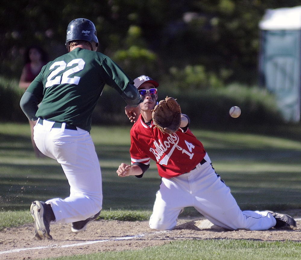 GOTCHA: Hall-Dale High School’s Quinn Stebbins collects a throw to third to pick off Winthrop High School’s Mario Meucci Tuesday in Farmingdale.