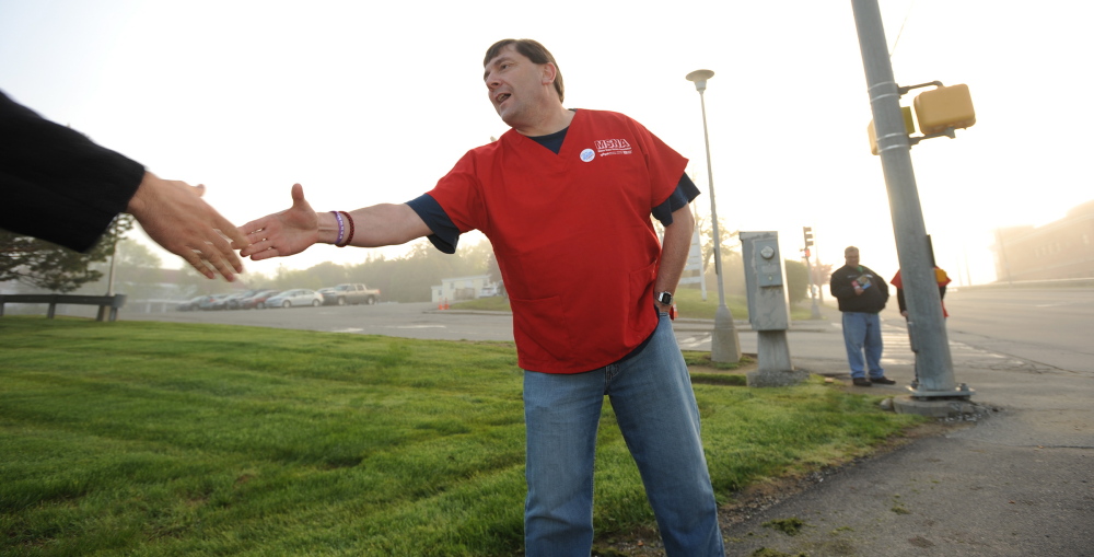 Kevin Bennett Photo Campaigning: Troy Jackson greets hospital workers on the street in front of Eastern Maine Medical Center in Bangor recently. Jackson was a looking to meet members of Maine State Nurses Association.