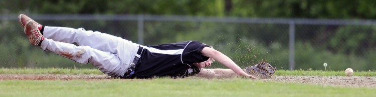 Slider: Richmond High School’s Brandon Emmons can’t collect a grounder Saturday on short during a baseball match up against Wiscasset in Richmond.