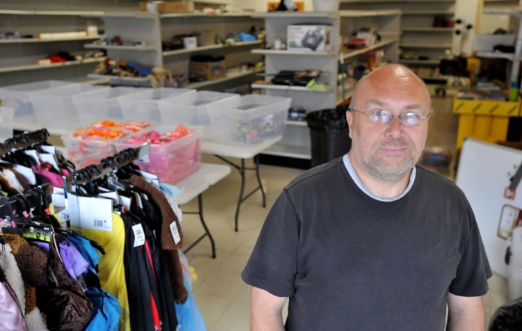 INVESTED IN THE SOUTH END: Jim Hamilton stands in his new business space, Hamilton’s Liquidation on Water Street in Waterville on Thursday.