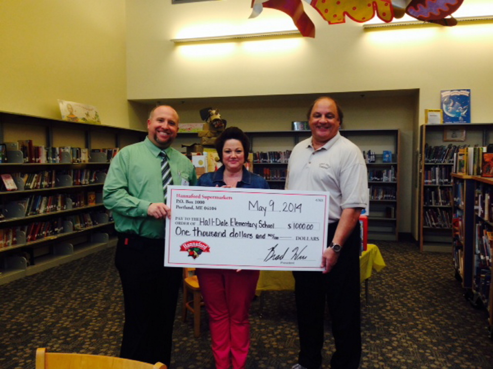 Hannaford Supermarket on Whitten Road in Augusta presented a $1,000 check to Hall-Dale Elementary School for the 2013-2014 Hannaford Helps Schools Campaign. From left are store manager Clint Rackliff; customer service manager Liz Bellerose; and Dana Folsom, principal of Hall-Dale Elementary School. Schools use the donations for items such as computers, musical instruments, sports gear, field trips or playground equipment.