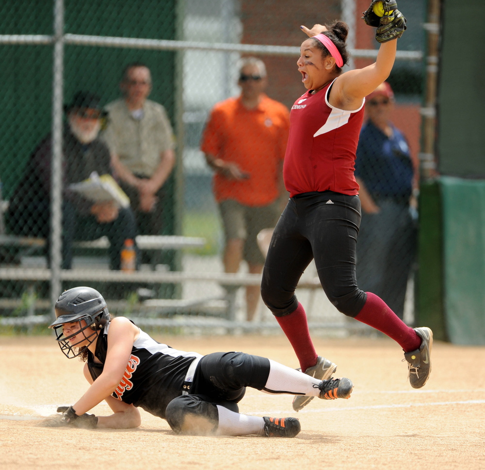 Celebration: Richmond High School first baseman Kelsie Obi, 18, right, celebrates after doubling up Limestone’s Annie Sinclair, 11, in the sixth inning of the Maine Principals Association Class D championship game at Brewer High School on Saturday. Richmond defeated Limestone 11-5.