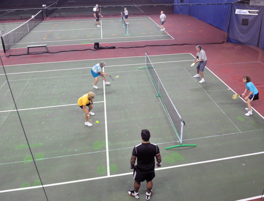 People play four games in the space of two tennis courts during a pickleball clinic on Saturday at A-COPI Tennis and Sports Center in Augusta.