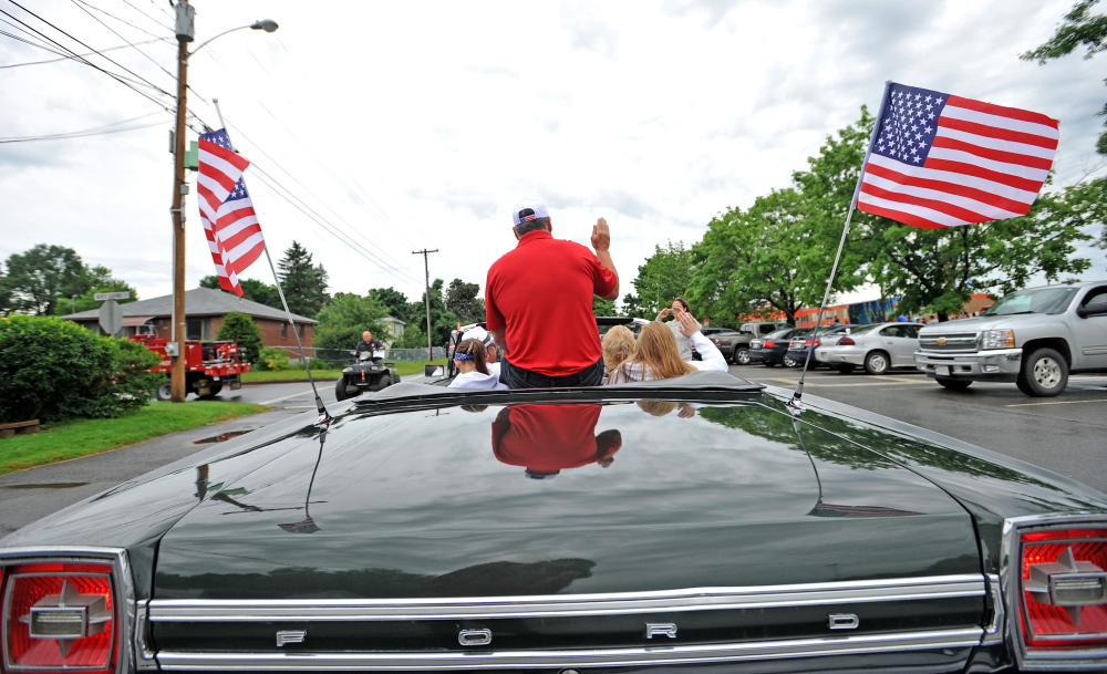 Kim Marshall, grand marshal of the Winslow Family 4th of July Celebration parade, waves to paradegoers Saturday.