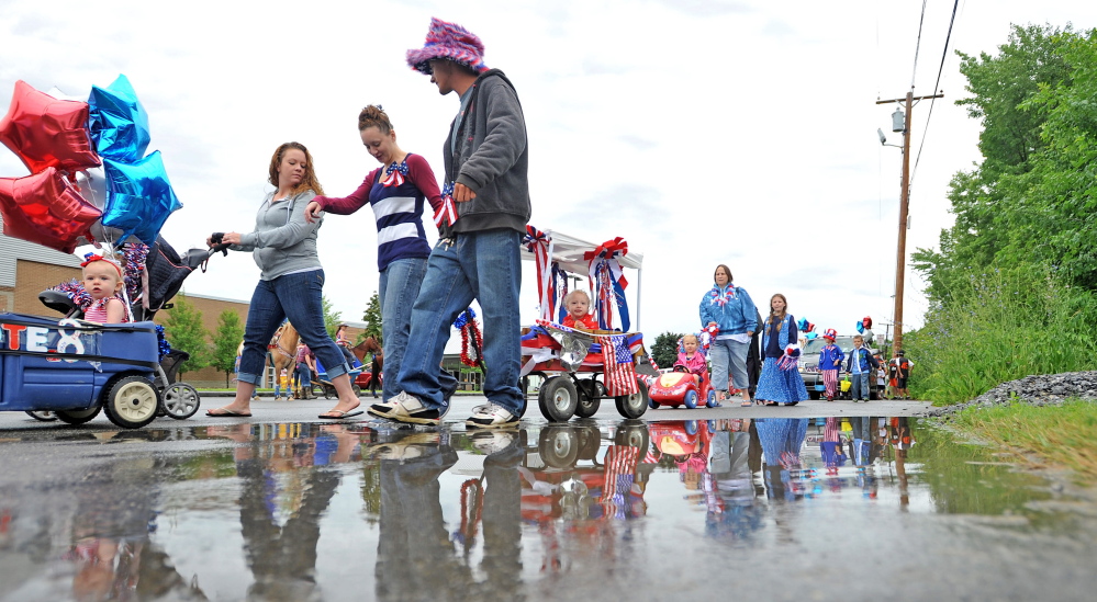 Winsow Family 4th of July Celebration parade participants march on Danielson Street in front of Winslow High School on Saturday.