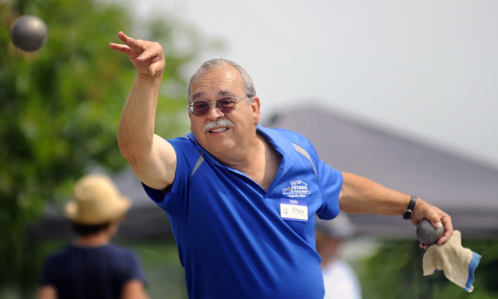 Ray Fecteau casts a petanque ball Sunday during a tournament match at Mill Park in Augusta.